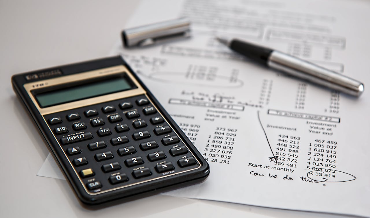 digital Close-up of financial documents with calculator and pen, ideal for business management themes.